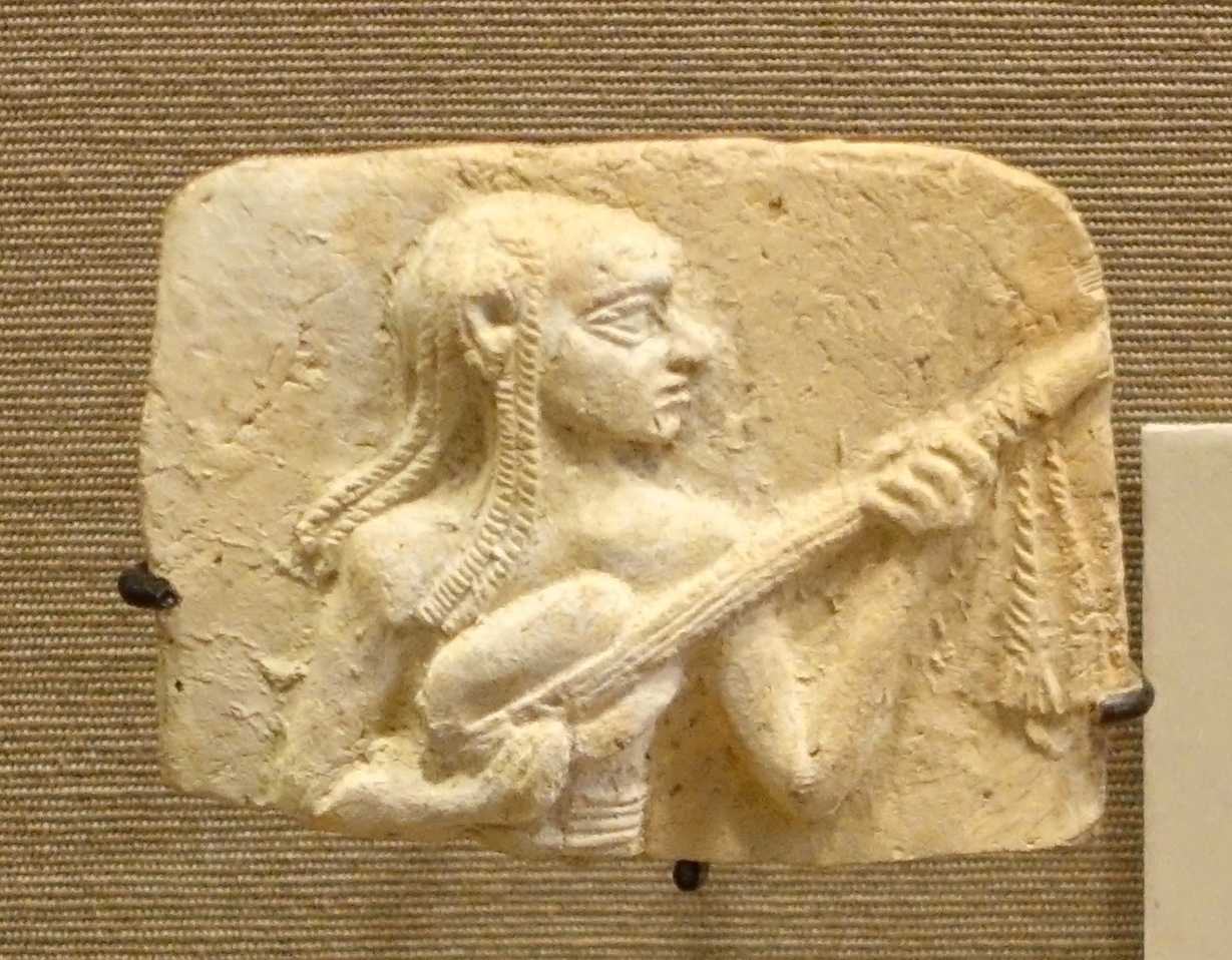 Musician holding and early lute, ancestor to the guitar
