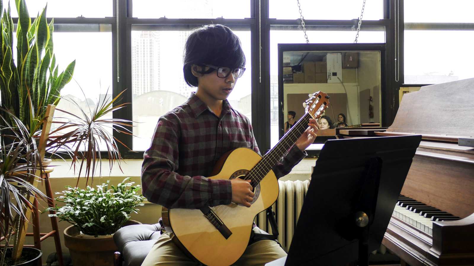 Student performing on guitar at the Sage Music recitals