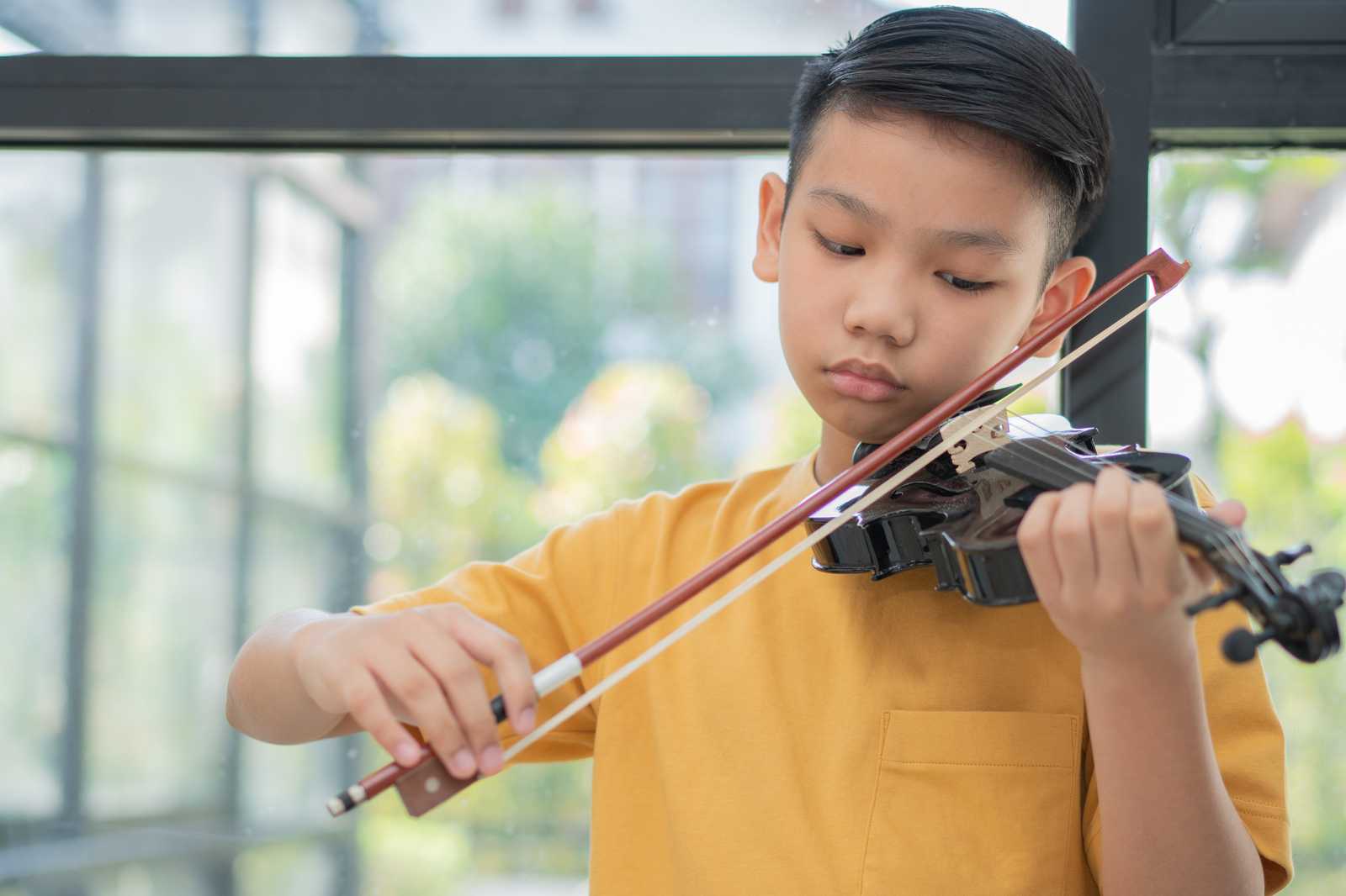 a girl practicing violin at home