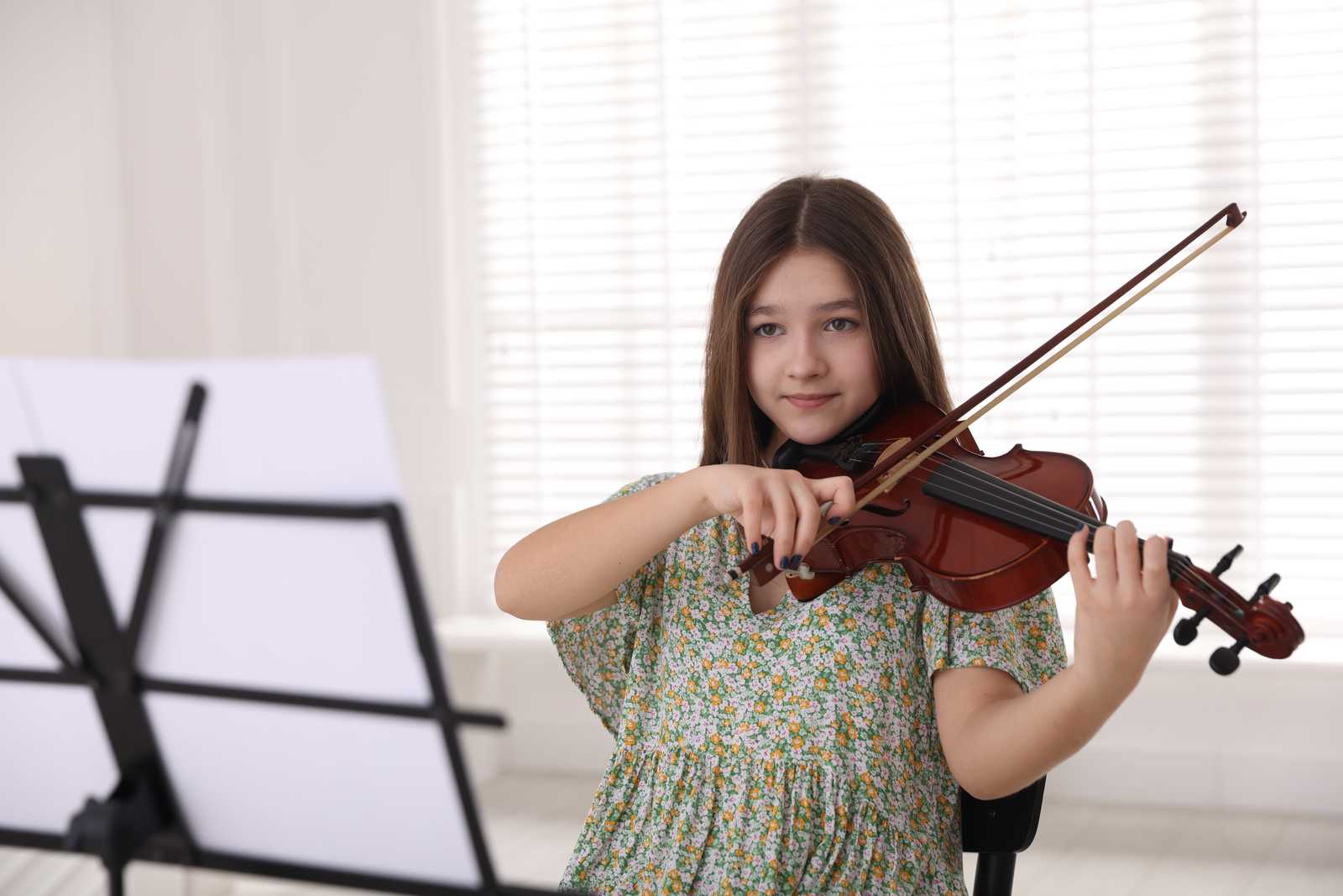 a girl practicing violin at home