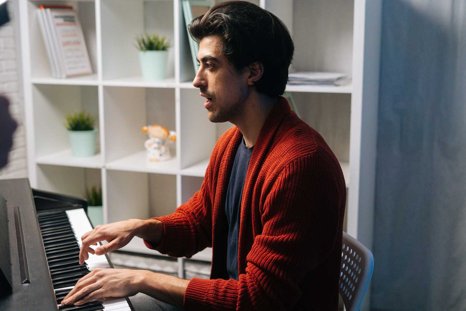 a man singing at the keyboard