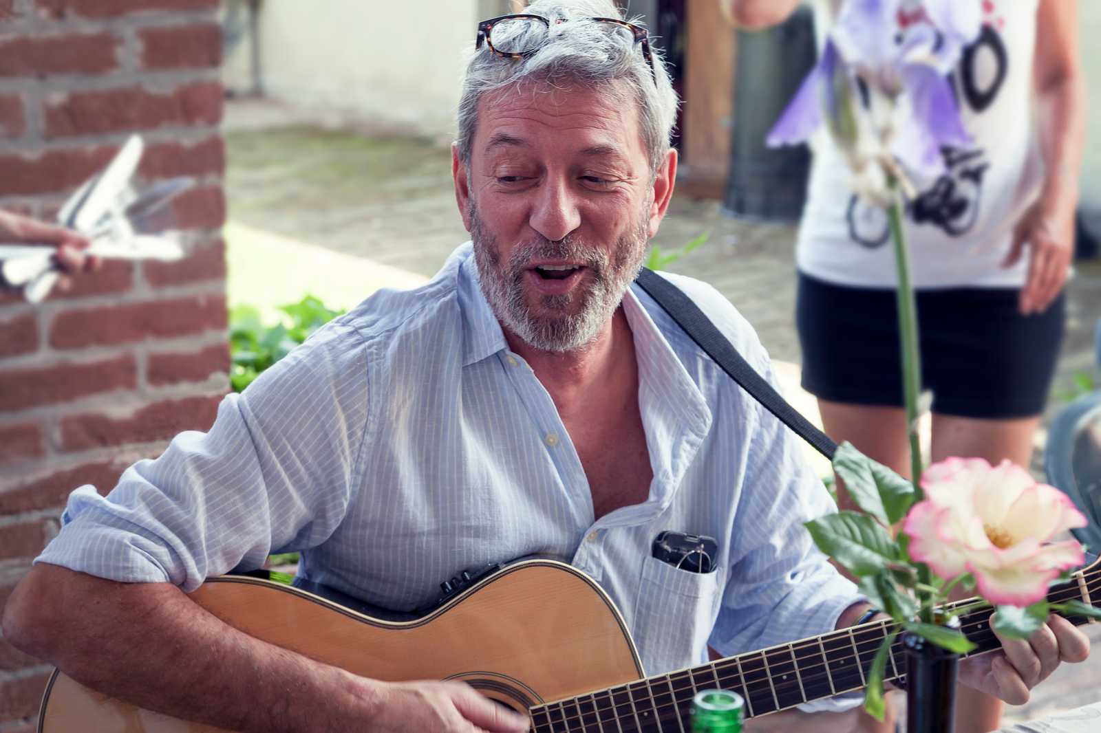 a man singing outside with his guitar