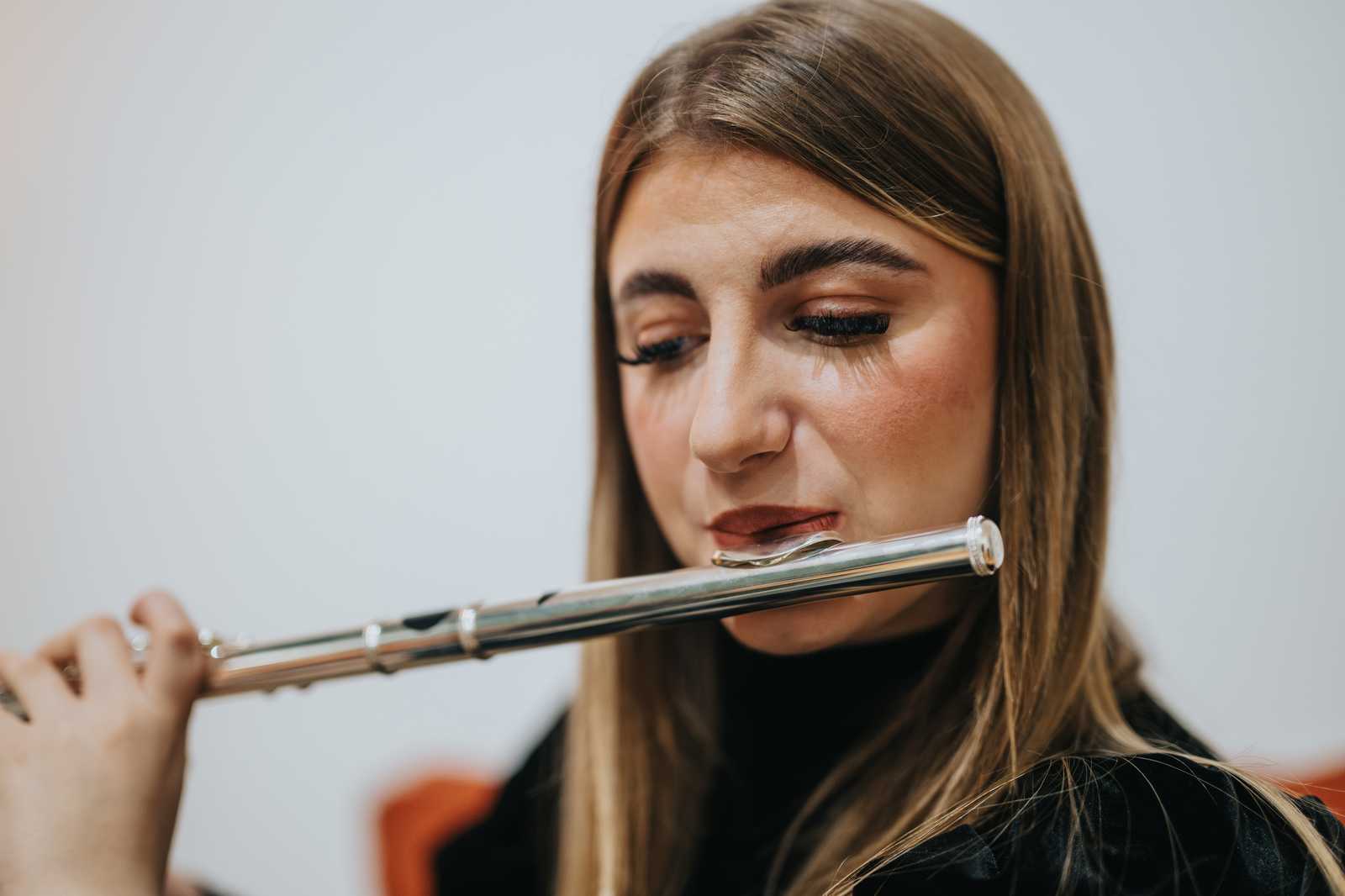 a woman practicing the flute