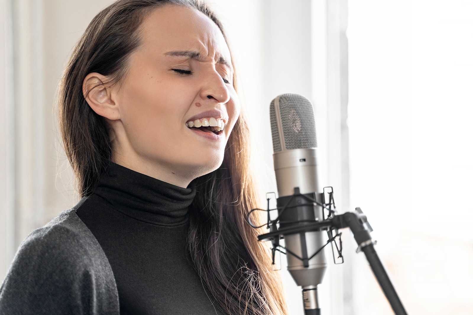 A woman singing with a microphone