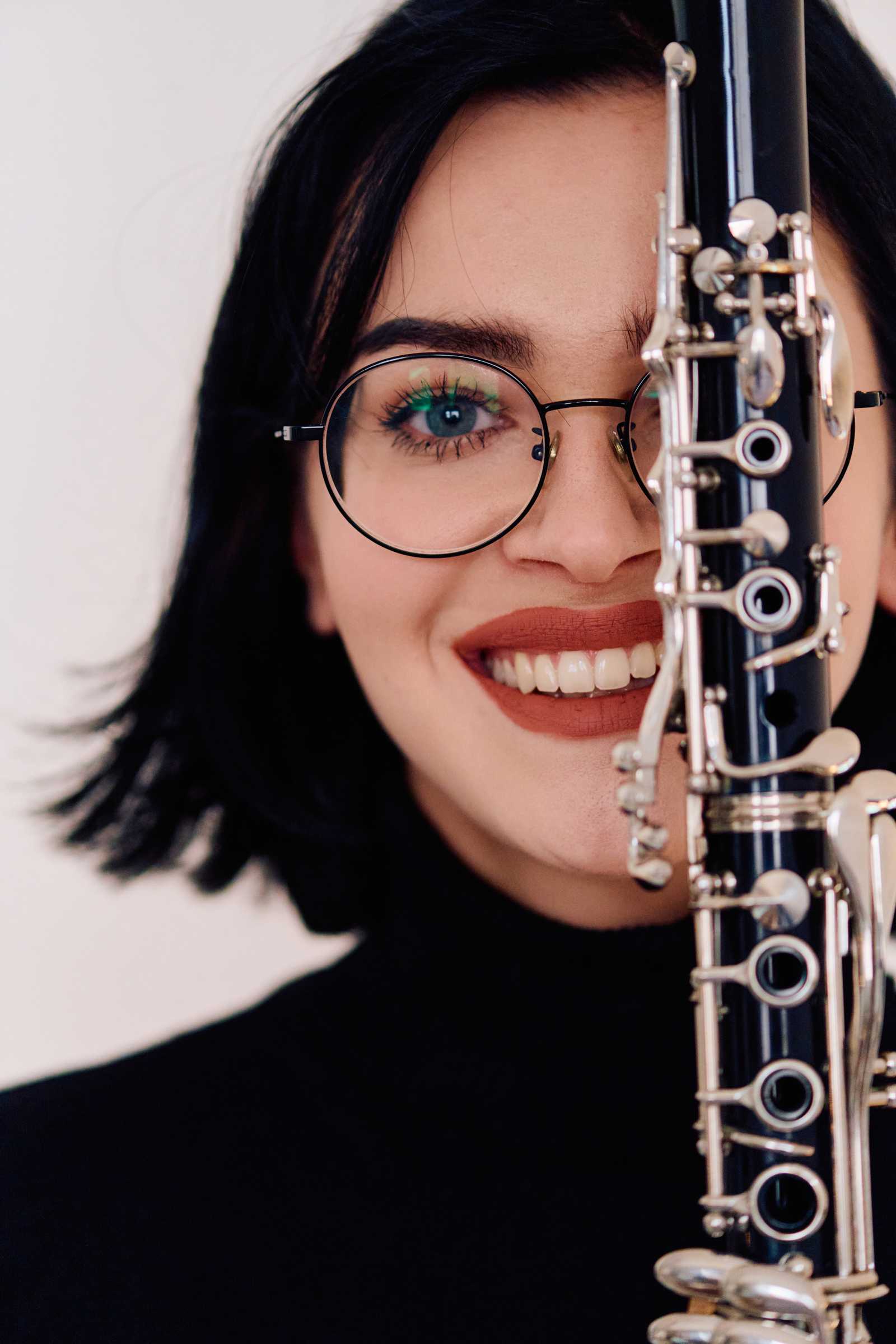 a woman smiling with her clarinet