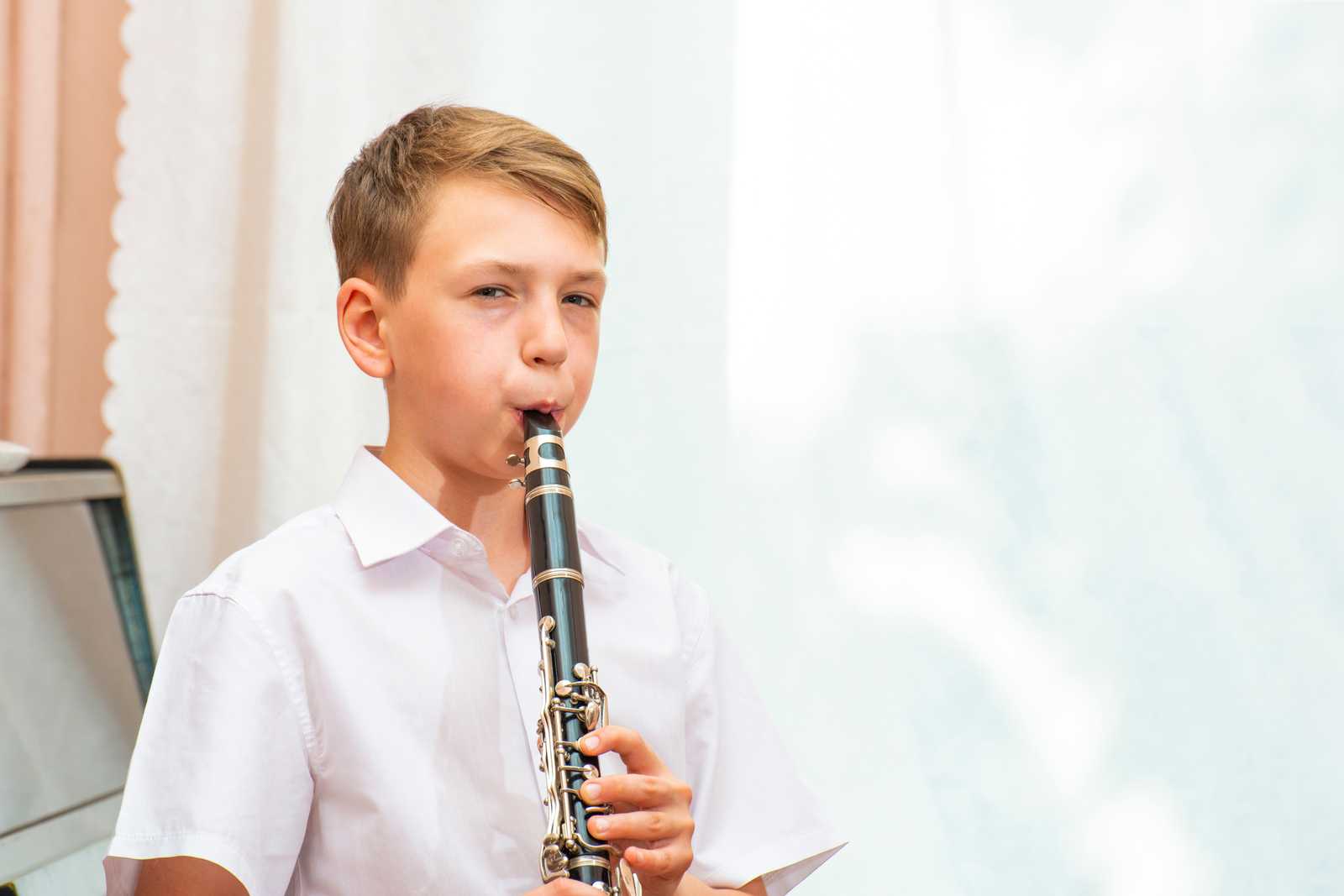 a young boy playing the clarinet