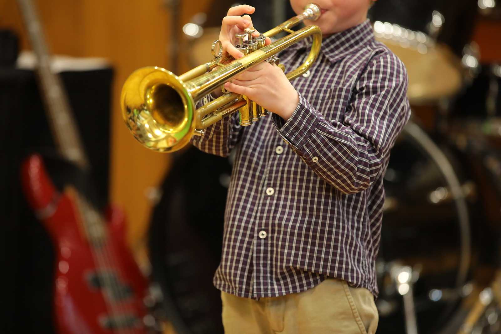A young boy playing the trumpet