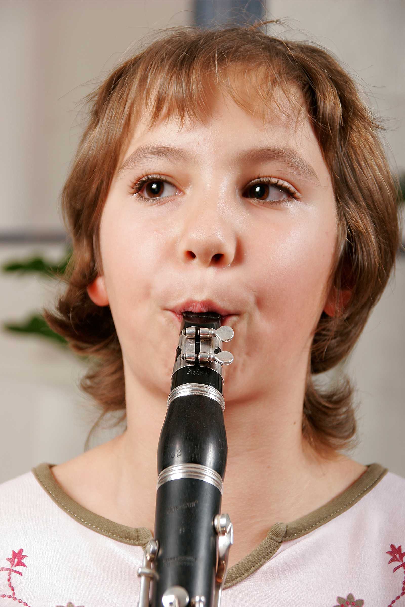 a young girl playing clarinet