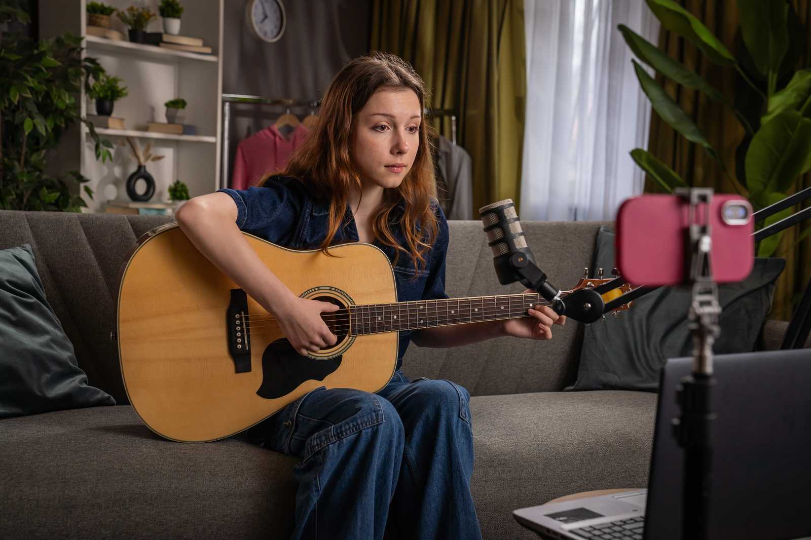 a young woman singing with guitar online