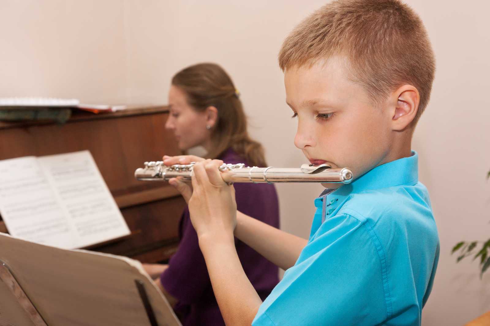 A boy playing the flute