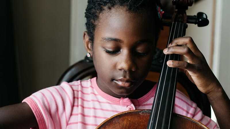 A young girl playing the cello