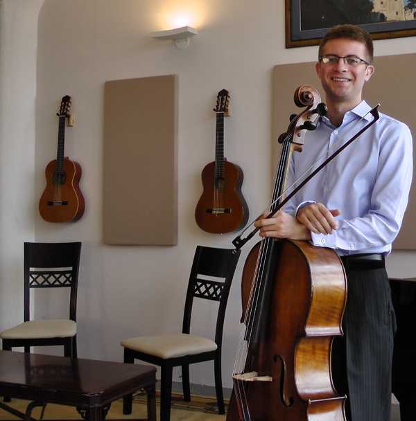 A teacher holding his cello