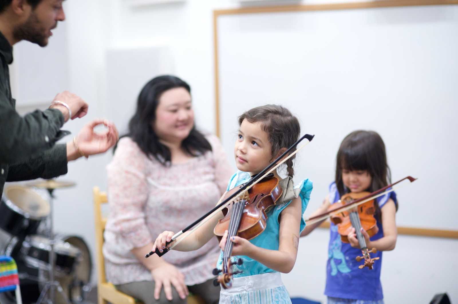 Two young girls taking a violin class at Sage Music