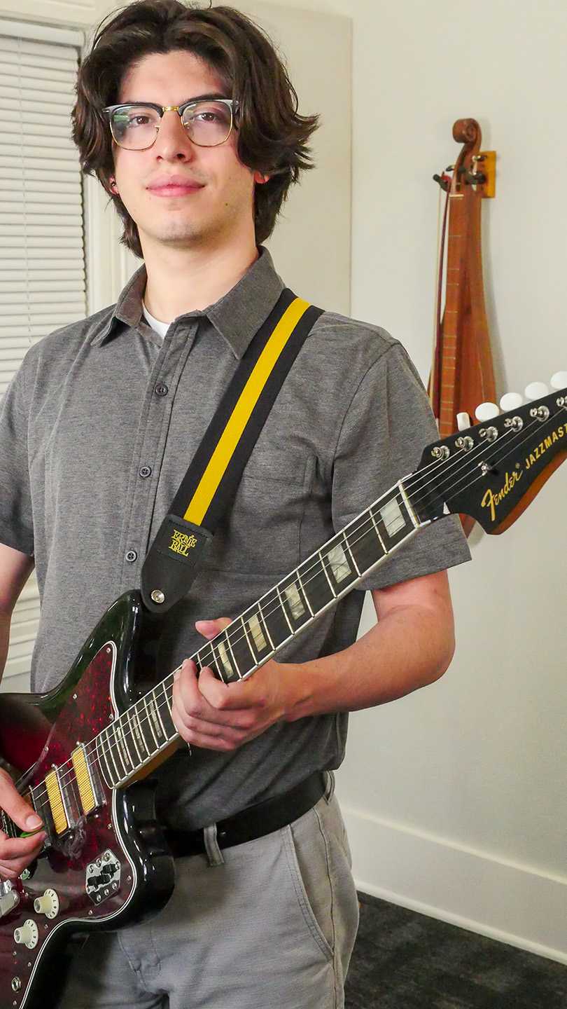 A man holding and electric guitar