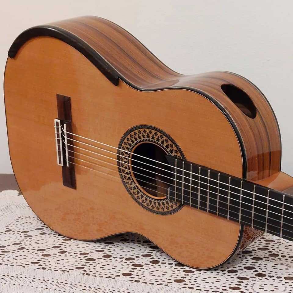 A guitar with a soundport and an armrest