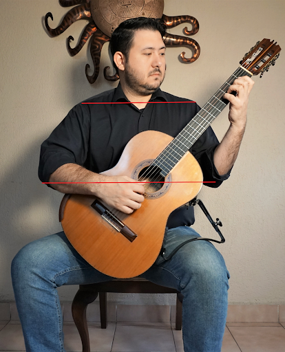 Good seated posture for holding the guitar, front view
