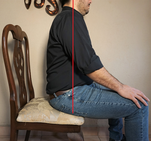Good seated posture for holding the guitar, side view