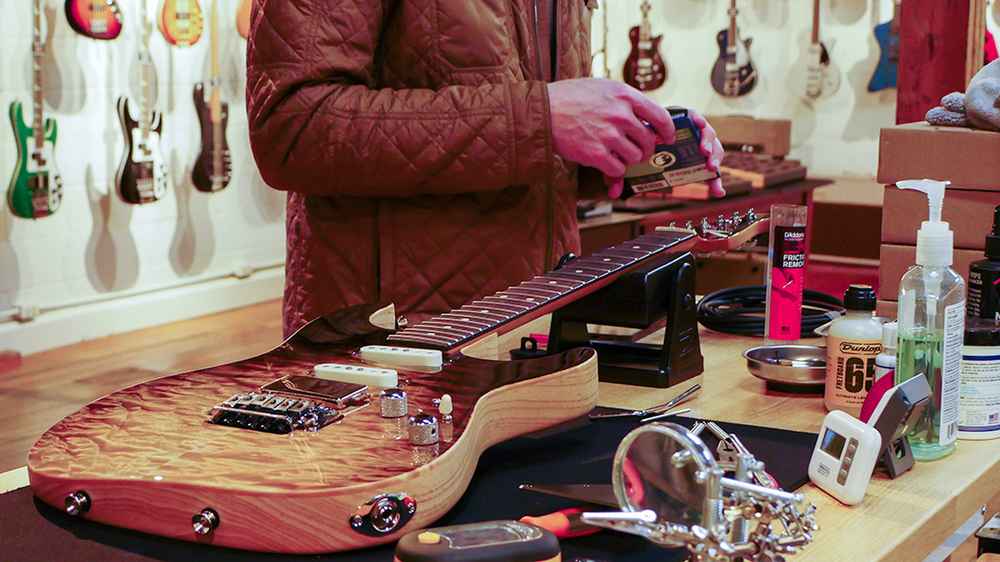 Restringing a guitar at Lark Guitars