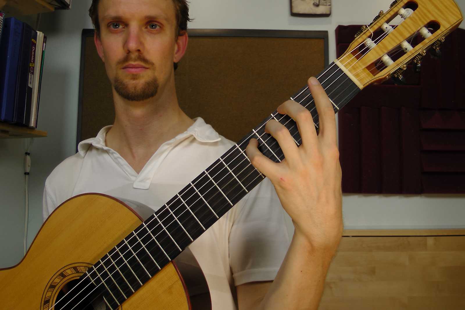 Left wrist is arched and deviated. A poor position on the guitar.