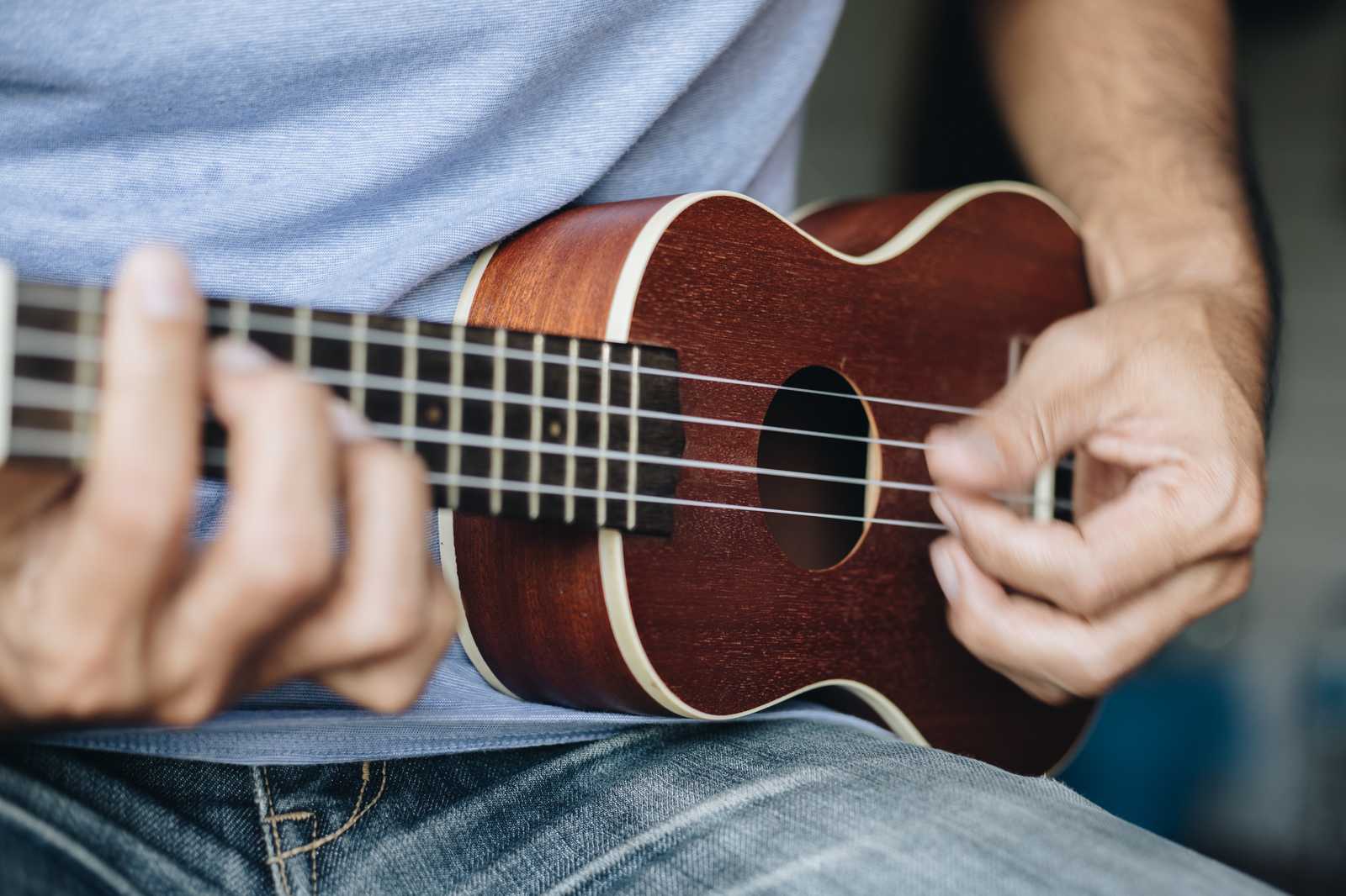 A man playing the ukulele