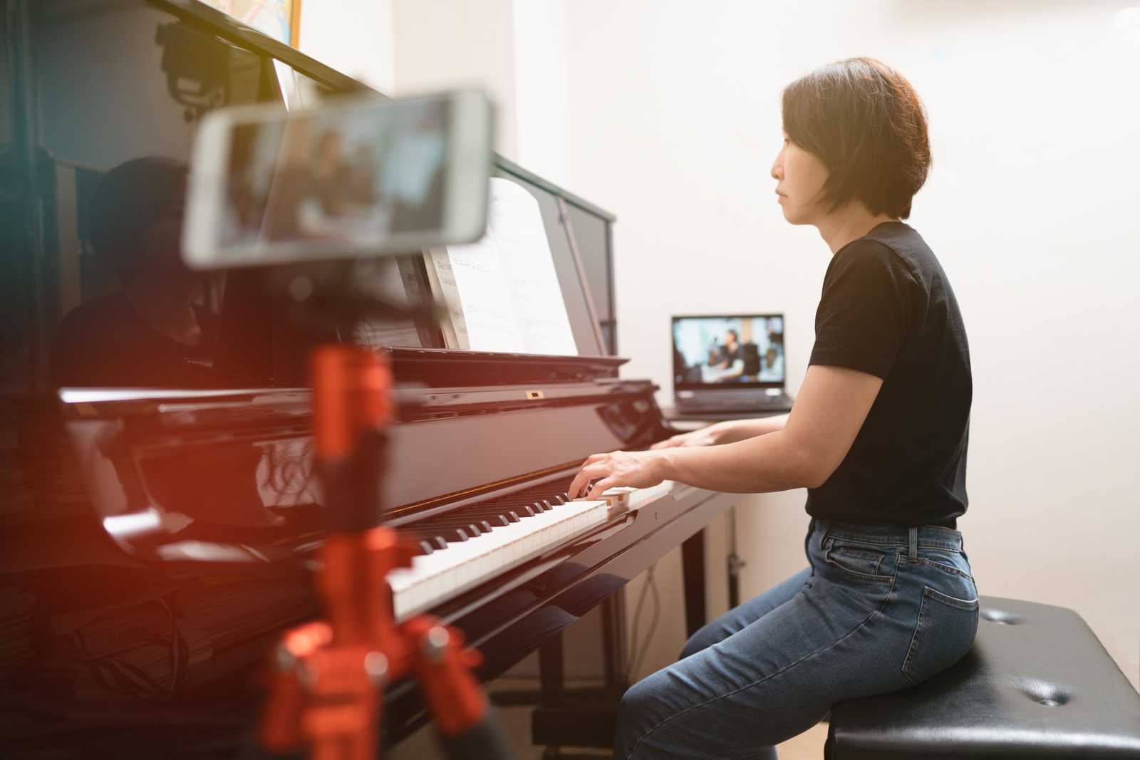 Piano lesson online with phone and computer setup