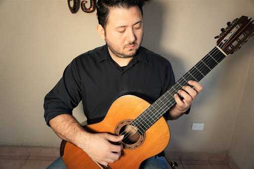 Position check, left hand on the guitar near the middle of the fretboard