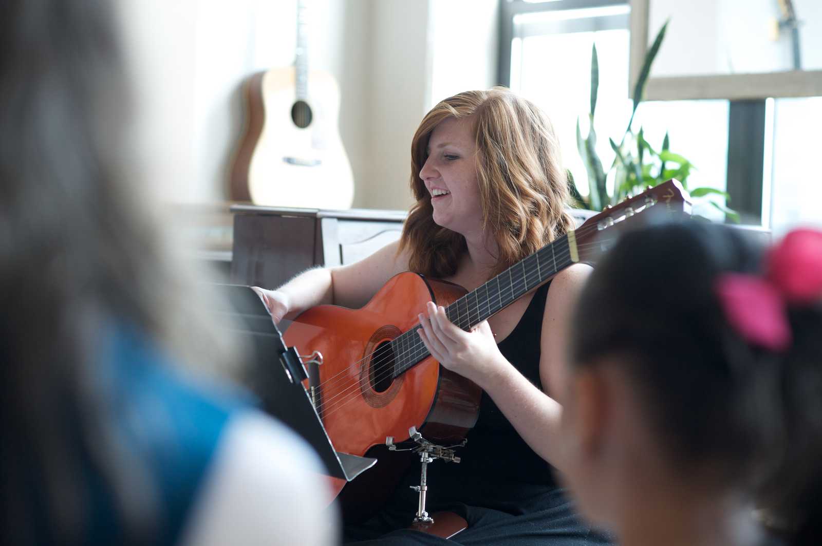 Sage Music Student playing guitar in recital