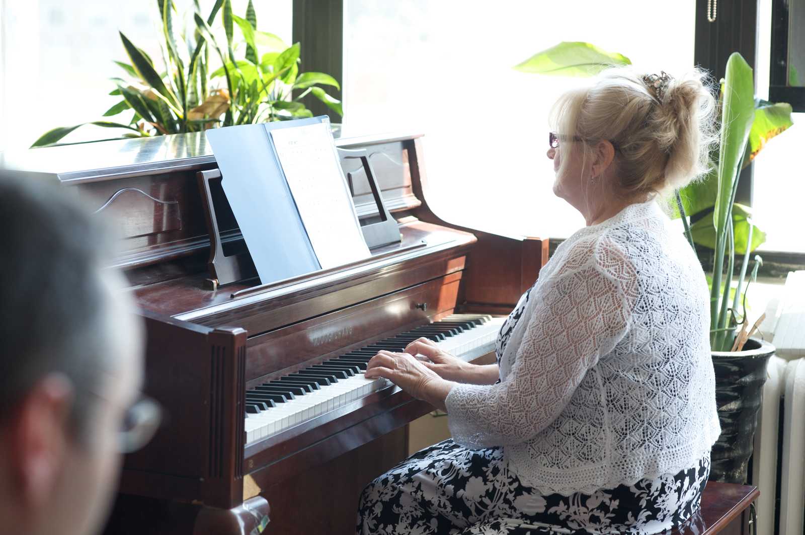 A woman performing on the piano in a recital