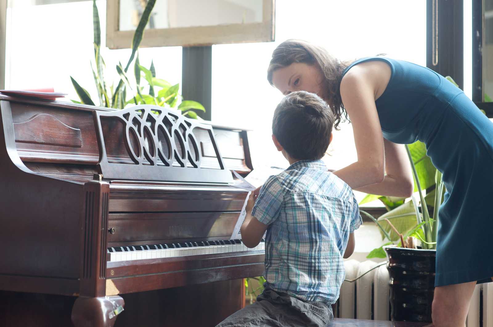Teacher helping a student get ready at recital