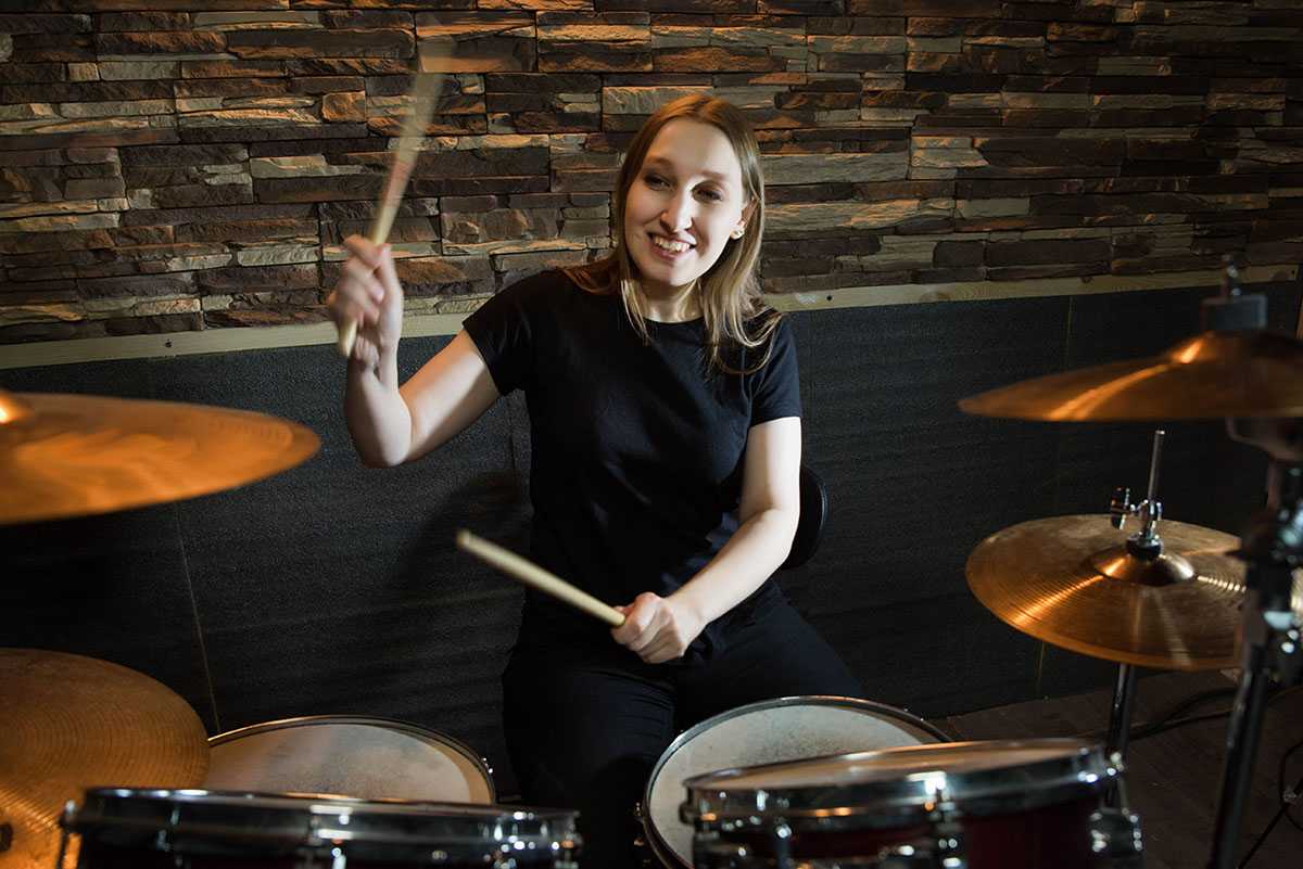Woman playing the drum set