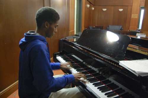 a young man playing piano
